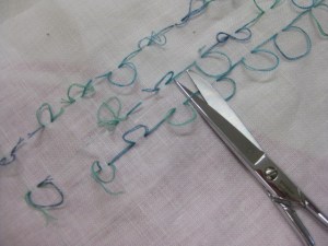 Continuous tailor's tacks stitched through both sides of garment piece to mark fold line for tucks and pleats.  They can be clipped apart between each tack to separate fabric layers.