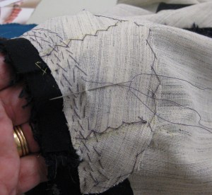 Back neckline support piece held over my hand to build in curved shape with small pad-stitches.