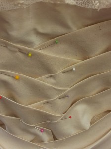 Toile version pinned in place on dress form