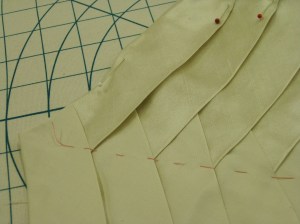 Tacked in place through centre front