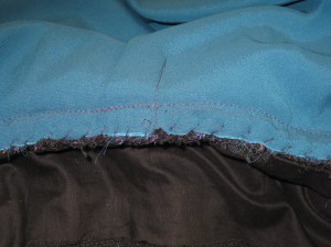 Neckline seam allowances of under collar and upper collar whipped together.