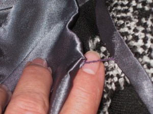 Hem finished with Hong Kong binding; French tack secures lining and top of hem