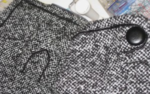 Russia braid applied by hand around outer edges of jacket, sleeve and pocket tab.