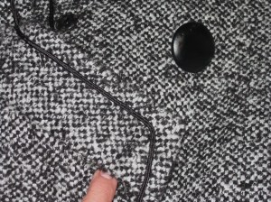 Inseam buttonhole, faux leather button and large snap on underside