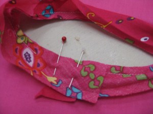 Lap approximately 2cm over the stitched trim and stitch in place