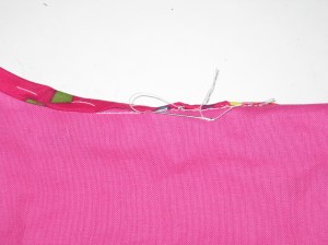 Hand stitch from just under the fold to the seam stitching