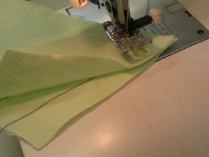 Wrap thread back around the needle and take stitch across the corner.