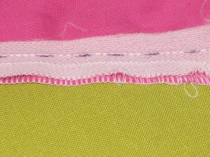 Pin underlap on underside of zipper tape