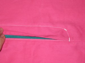 With fly facing in place underneath, stitch bar tack at bottom of zipper at CF and on curve of topstitching - to catch fly facing and keep in in place.