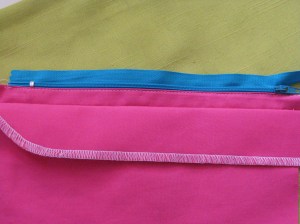 Using zipper foot, stitch on the seam allowance close to the zipper teeth and along the length of the zipper.