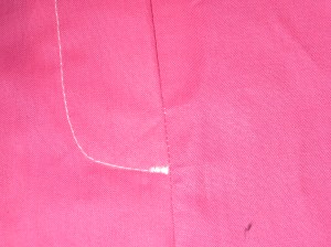 Use a small zigzag to make a small bartack at CF at the base of the topstitching.