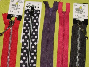 A selection - Left to right are metal zip; decorative tapes; regular dress zip; lightweight dress zip; metal zip