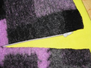 Concealed front closure with open end zipper.