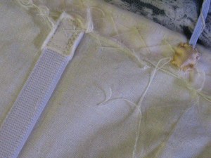 Ends of boning are covered for the comfort of the wearer.