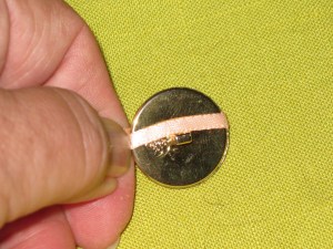 Wrap ribbon around dome button right beside the shank - underside.