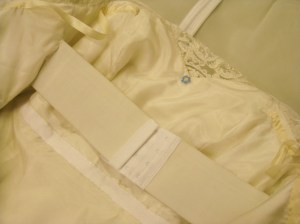 Elastic stay and Petersham waist stay are lie inside the gown - over the silk lining (inserted by hand).