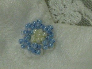 The final touch - a hand beaded blue flower for luck.