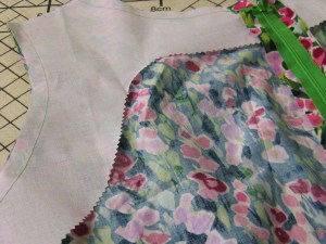 Sew in interfacing tacked in place to support neckline and armholes.