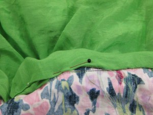 Lining mid section hand stitched to garment seam allowance at top of skirt section.