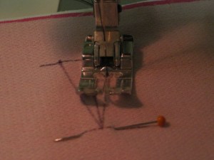 Using small stitch length, start along one long side and stitch around the triangular shape.