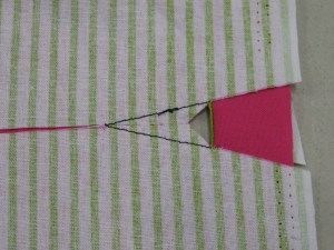 Turn buttonhole fabric to wrong side along base.