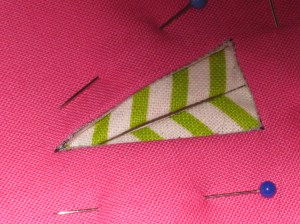 Position faced hole in facing over the underside of the buttonhole and handstitch in place.