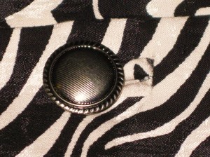 Button sits at the point of the buttonhole.