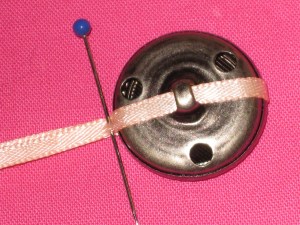 Wrap thin ribbon around the button and mark the width.