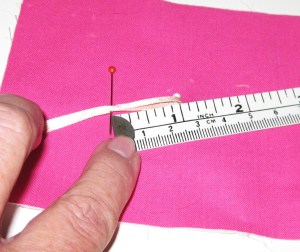 Lay the ribbon flat and measure from the fold to the mark. Add 3mm/ 1/8" and this will be the required opening.