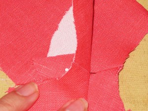 Pin through facing seam allowance and then through garment seam allowance to ensure seam lines are aligned.