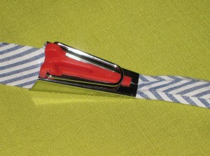 Feed fabric strip into bias maker. Press folded edges as you slowly slide the bias maker along the strip.