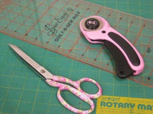 Dressmaking shears with rotary cutter, mat and ruler.