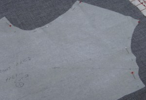 I prefer to pin within the seam allowance and parallel with the seam line. Make sure corners and the mid point of curves are pinned so they will not move when fabric is being cut.