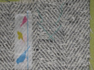 Use a piece of Washi tape or a hand stitch to indicate the wrong side of the fabric.