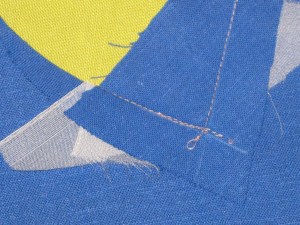 Stitch through the point on one side - keeping the stay stitching in view.