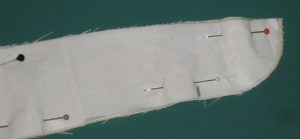 After fusing, reposition pattern piece and trim accurately. Fabric can stretch or distort during the fusing process.