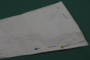 Under collar pattern has been placed on top of upper collar, matching CB position. Front edges of collar remain in the same position on both pieces. Narrow wedge trimmed from front edge.