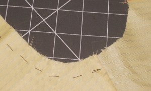 If using a double yoke, tack both pieces together at neckline (on the garment side so tacking will not be caught in stitching). This will keep neckline edges together and minimise problems when attaching the stand.