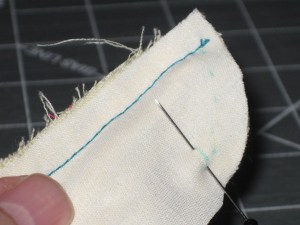 Wrap stand pieces over the rolled section and pin together at CF.