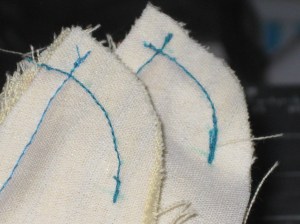 Both ends stitched from neckline to CF. Check the curves match.