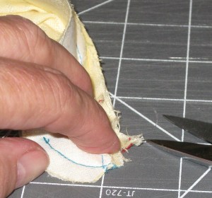 Trim the folded or pieced tab section between the stand seam allowances; clip across turn from neckline into stand.