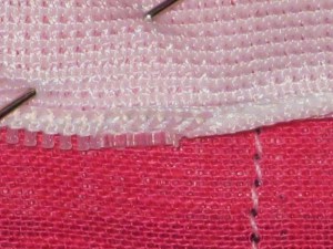 Align top of zipper just under the keyed stitching line