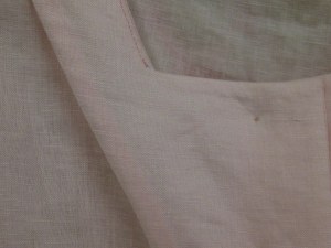 Facing the facing with lightweight fusible interfacing results in a neat, smooth finish on the inside of the garment - no shadow of overlocking can be seen from the right side of a light coloured garment.