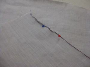 Roll the hem to the underside; pin in place