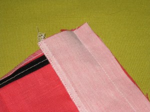Facing stitched to the edge - zipper tapes are not caught in the seam.