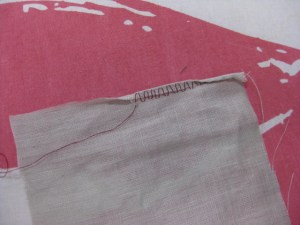 Roll under one third of hem width. Hand stitch in the fold and another third below the cut edge.