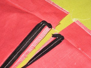 Facing stitched to the edge - zipper tapes are not caught in the seam.