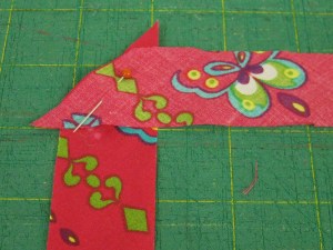 Place bias strips at right angles and stitch across the angle.