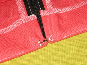 Add hook and eye and hand stitch the bottom of the facing to the seam allowance.