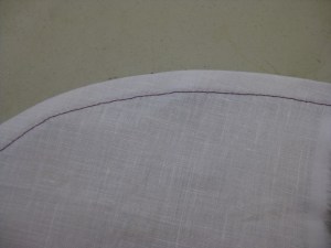 Narrow curved hem which has been machine stitched